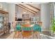 Charming dining room with vaulted ceilings, exposed wooden beams, stone fireplace, and wood table with seating for six at 125 Sumners Aly, Summerville, SC 29485