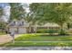 Charming home featuring a lush lawn, mature trees, and a two-car garage, blending elegance with natural beauty at 125 Sumners Aly, Summerville, SC 29485