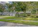 A beautiful single-Gathering home has a well-manicured lawn, mature tree and brick exterior at 125 Sumners Aly, Summerville, SC 29485