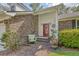 Inviting front porch with brick flooring, decorative wreath, and quaint seating area at 125 Sumners Aly, Summerville, SC 29485
