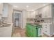 Well-lit kitchen with a view into laundry room, featuring white cabinetry, gray backsplash, and stainless steel appliances at 125 Sumners Aly, Summerville, SC 29485