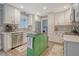 Modern kitchen featuring white cabinetry, gray backsplash, stainless steel appliances, and a vibrant green island at 125 Sumners Aly, Summerville, SC 29485