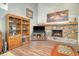 Stylish living room with a stone fireplace, built-in shelving, flat screen TV and cozy seating, perfect for relaxation at 125 Sumners Aly, Summerville, SC 29485