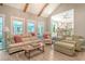 Bright living room with vaulted ceilings, wooden beams, comfortable seating, and a view of the kitchen and sunroom at 125 Sumners Aly, Summerville, SC 29485