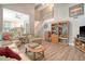 Open living room showcasing a staircase, vaulted ceilings, a stone fireplace, and seamless flow into the kitchen at 125 Sumners Aly, Summerville, SC 29485