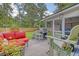 Charming outdoor patio with comfortable seating, grill, and screened in porch overlooking a well-manicured lawn at 125 Sumners Aly, Summerville, SC 29485
