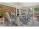 Enclosed porch area with dining table and comfortable seating, perfect for enjoying the outdoors at 125 Sumners Aly, Summerville, SC 29485