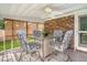 Enclosed screened porch with a ceiling fan and dining set that is perfect for outdoor dining at 125 Sumners Aly, Summerville, SC 29485