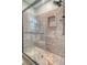 Walk-in shower featuring granite tile and frameless glass enclosure at 125 Sumners Aly, Summerville, SC 29485
