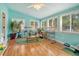 Bright sunroom featuring hardwood floors and ample natural light from surrounding windows at 125 Sumners Aly, Summerville, SC 29485