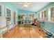 Bright sunroom with hardwood floors, light blue walls, and large windows at 125 Sumners Aly, Summerville, SC 29485