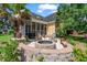 Backyard with a brick fire pit, wood chairs and a yellow house at 129 Saluda Dr, Moncks Corner, SC 29461