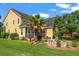 Exterior view of a yellow home with a screened in porch and brick fire pit at 129 Saluda Dr, Moncks Corner, SC 29461