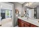 Well-lit bathroom featuring a wood vanity, white countertops, and a view into the bedroom at 129 Saluda Dr, Moncks Corner, SC 29461