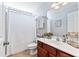 Well-lit bathroom with tiled floors, a white shower curtain, and a cherry wood vanity at 129 Saluda Dr, Moncks Corner, SC 29461