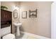 Bathroom featuring a pedestal sink, toilet, and wall mounted storage at 129 Saluda Dr, Moncks Corner, SC 29461