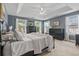 Bright bedroom with a tray ceiling, black furnishings, and two sunny windows at 129 Saluda Dr, Moncks Corner, SC 29461