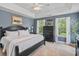 Comfortable bedroom with a black bed frame, natural light from the windows, and ceiling fan at 129 Saluda Dr, Moncks Corner, SC 29461
