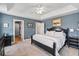 Bedroom featuring a tray ceiling, neutral walls, black furniture, and carpeted floors at 129 Saluda Dr, Moncks Corner, SC 29461