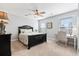 Light bedroom with a black bed frame, ceiling fan, and natural light from the windows at 129 Saluda Dr, Moncks Corner, SC 29461
