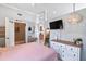 Bright bedroom with a pink bed, a mirror, a flat screen tv, and decor at 129 Saluda Dr, Moncks Corner, SC 29461