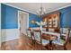 Cozy dining room with wood floors, wainscoting, and dark blue walls at 129 Saluda Dr, Moncks Corner, SC 29461