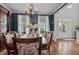 Elegant dining room featuring hardwood floors, blue textured walls, and decorative chandelier at 129 Saluda Dr, Moncks Corner, SC 29461