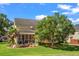 A yellow house is surrounded by a green lawn and tall green trees at 129 Saluda Dr, Moncks Corner, SC 29461