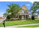 Charming yellow home with a manicured lawn, lush landscaping, and inviting front porch at 129 Saluda Dr, Moncks Corner, SC 29461