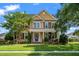Charming two-story home featuring a covered front porch, a well-manicured lawn, and mature trees at 129 Saluda Dr, Moncks Corner, SC 29461