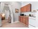 Kitchen featuring upper cabinets, a microwave, and an adjacent room with a curtain doorway at 129 Saluda Dr, Moncks Corner, SC 29461