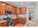Well-equipped kitchen with granite countertops, stainless appliances, and dark wood cabinets at 129 Saluda Dr, Moncks Corner, SC 29461
