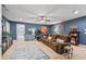 Cozy living room with a large sectional couch, blue accent wall, and access to another room at 129 Saluda Dr, Moncks Corner, SC 29461