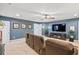 Living room featuring a large TV, a comfortable sectional couch, and blue accent wall at 129 Saluda Dr, Moncks Corner, SC 29461