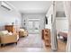 Brightly lit living area with comfortable chairs, a mini-split AC unit, and a view of the entrance at 129 Saluda Dr, Moncks Corner, SC 29461