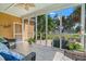 Enclosed porch offers outdoor views with wicker furniture and plants at 129 Saluda Dr, Moncks Corner, SC 29461