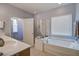 Bright bathroom features a walk-in shower, soaking tub, and natural light at 129 Schooner Bend Ave, Summerville, SC 29486