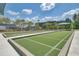 Outdoor bocce ball courts with turf surface surrounded by landscaping and shade at 129 Schooner Bend Ave, Summerville, SC 29486