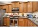 This kitchen features wooden cabinets, stainless steel appliances, and granite countertops at 129 Schooner Bend Ave, Summerville, SC 29486
