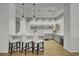 Stylish kitchen area featuring modern white cabinetry, sleek countertops, stainless steel appliances, and bar seating at 129 Schooner Bend Ave, Summerville, SC 29486