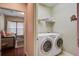 Convenient laundry room with washer, dryer, shelving, and natural light at 129 Schooner Bend Ave, Summerville, SC 29486