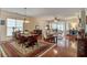 Open-concept living and dining area featuring hardwood floors, large windows, and stylish furnishings at 129 Schooner Bend Ave, Summerville, SC 29486