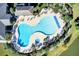 Aerial view of an inviting community pool and spa surrounded by lounge chairs, palm trees and lush landscaping at 129 Schooner Bend Ave, Summerville, SC 29486
