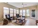 Bright sunroom with tile floors, many windows, and comfortable seating with side tables and lamps at 129 Schooner Bend Ave, Summerville, SC 29486