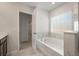 Soaking tub and ensuite bathroom leading to a walk-in closet at 1311 Berry Grove Dr, Summerville, SC 29485