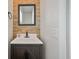 Bathroom vanity with a stone backsplash and modern dark brown cabinet and countertop at 1311 Berry Grove Dr, Summerville, SC 29485