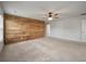 Primary bedroom with ceiling fan, neutral walls and carpet, and an accent wood wall at 1311 Berry Grove Dr, Summerville, SC 29485