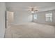 Bright primary bedroom with a ceiling fan, neutral walls and carpet, and natural light from two large windows at 1311 Berry Grove Dr, Summerville, SC 29485