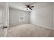 A cozy bedroom featuring a ceiling fan, neutral paint, and carpet, creating a serene and relaxing atmosphere at 1311 Berry Grove Dr, Summerville, SC 29485