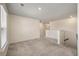 Well-lit bonus room with neutral walls and carpet, with stairs leading down to the lower level at 1311 Berry Grove Dr, Summerville, SC 29485